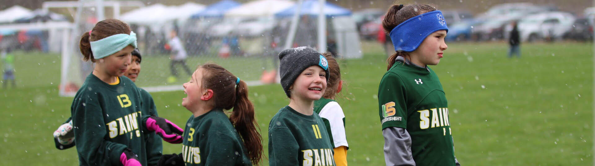 A group of girls wait for their next match with smiles